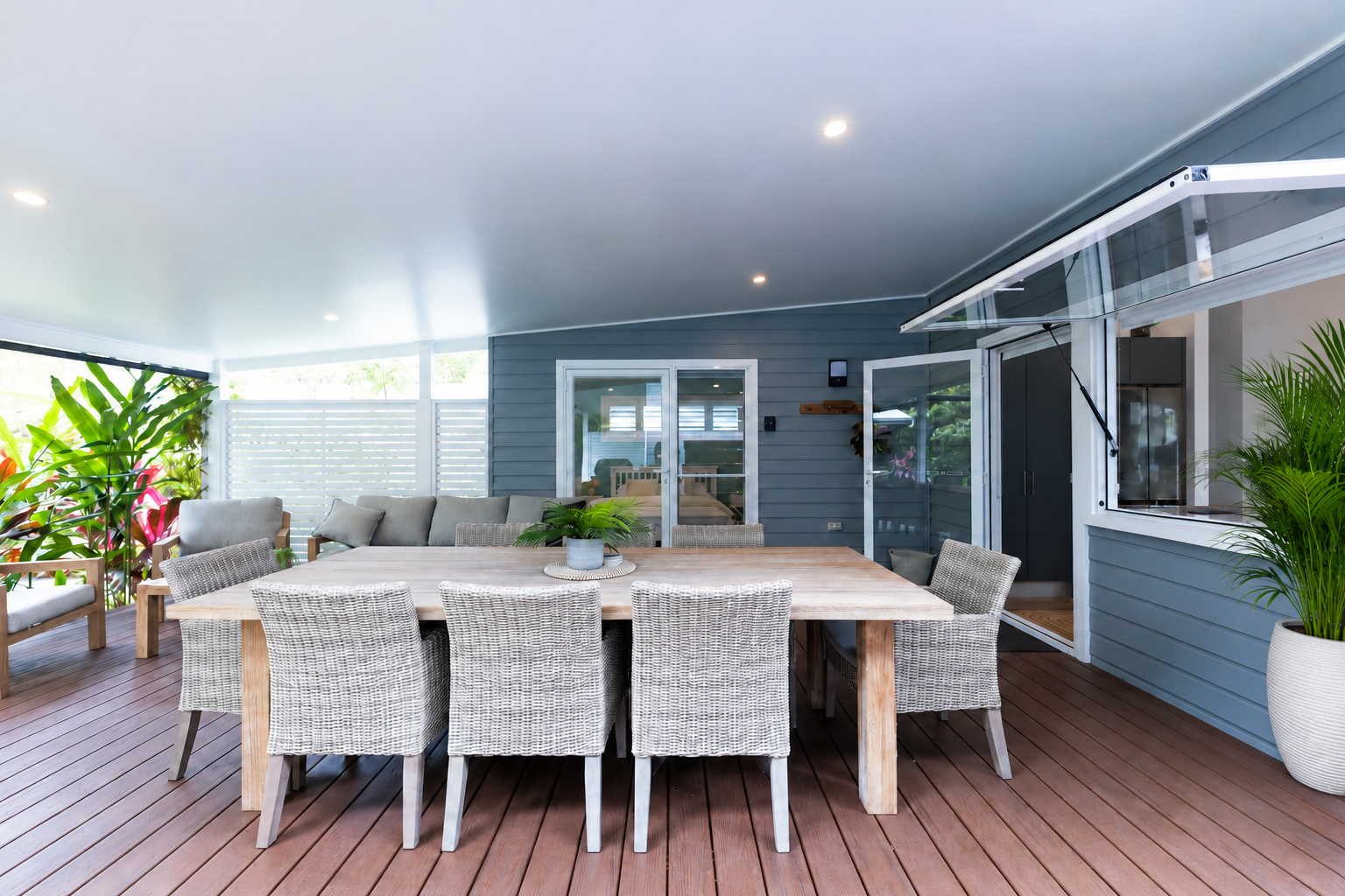 Kable House covered deck with outdoor dining and lounge seating